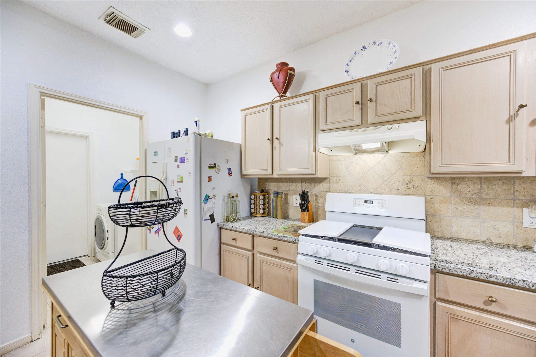 16730 Spring Barker Drive Cypress, TX 77429 - Photo 28 of 50 a kitchen with a stove cabinets and window