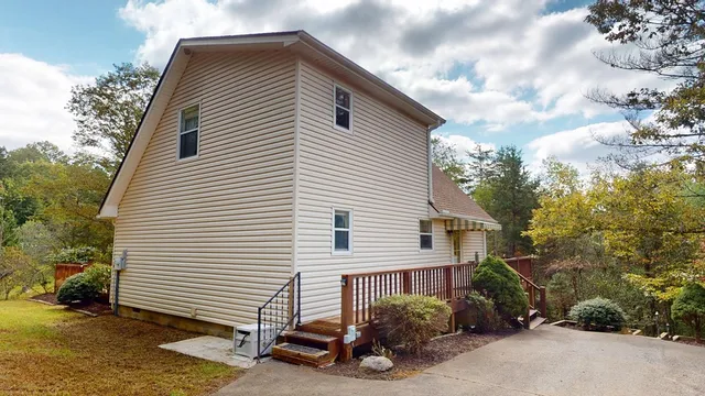 a balcony with wooden floor and trees in the back