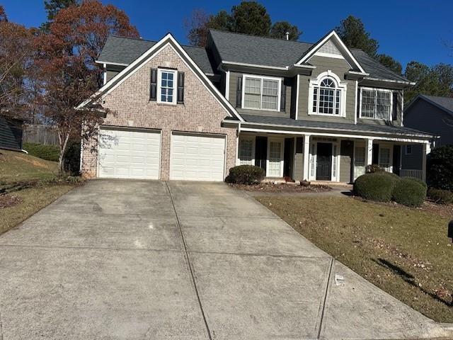 7030 Bennington Lane Cumming, GA 30041 - Photo 21 of 21 a front view of a house with a yard and garage