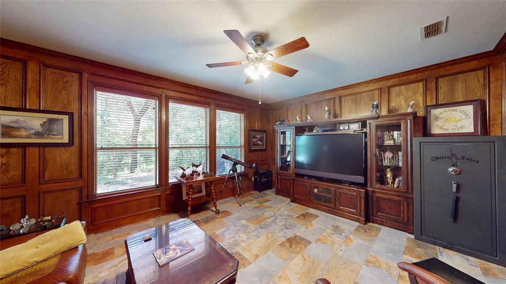 7451 County Road 1509 Athens, TX 75751 - Photo 13 of 36 a living room with furniture tv and a large window