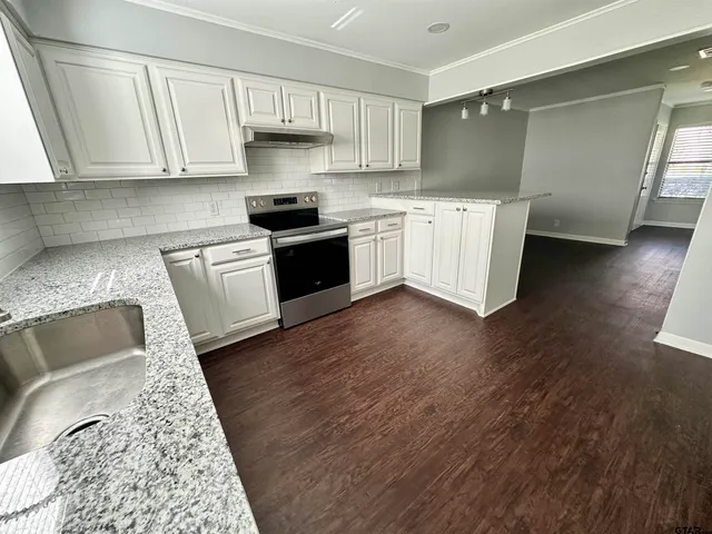 a kitchen with a sink and cabinets