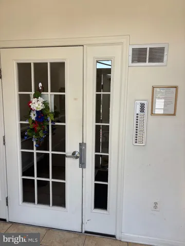 a view of a hallway with furniture and windows
