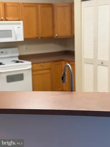 a kitchen with a stove a refrigerator and a sink