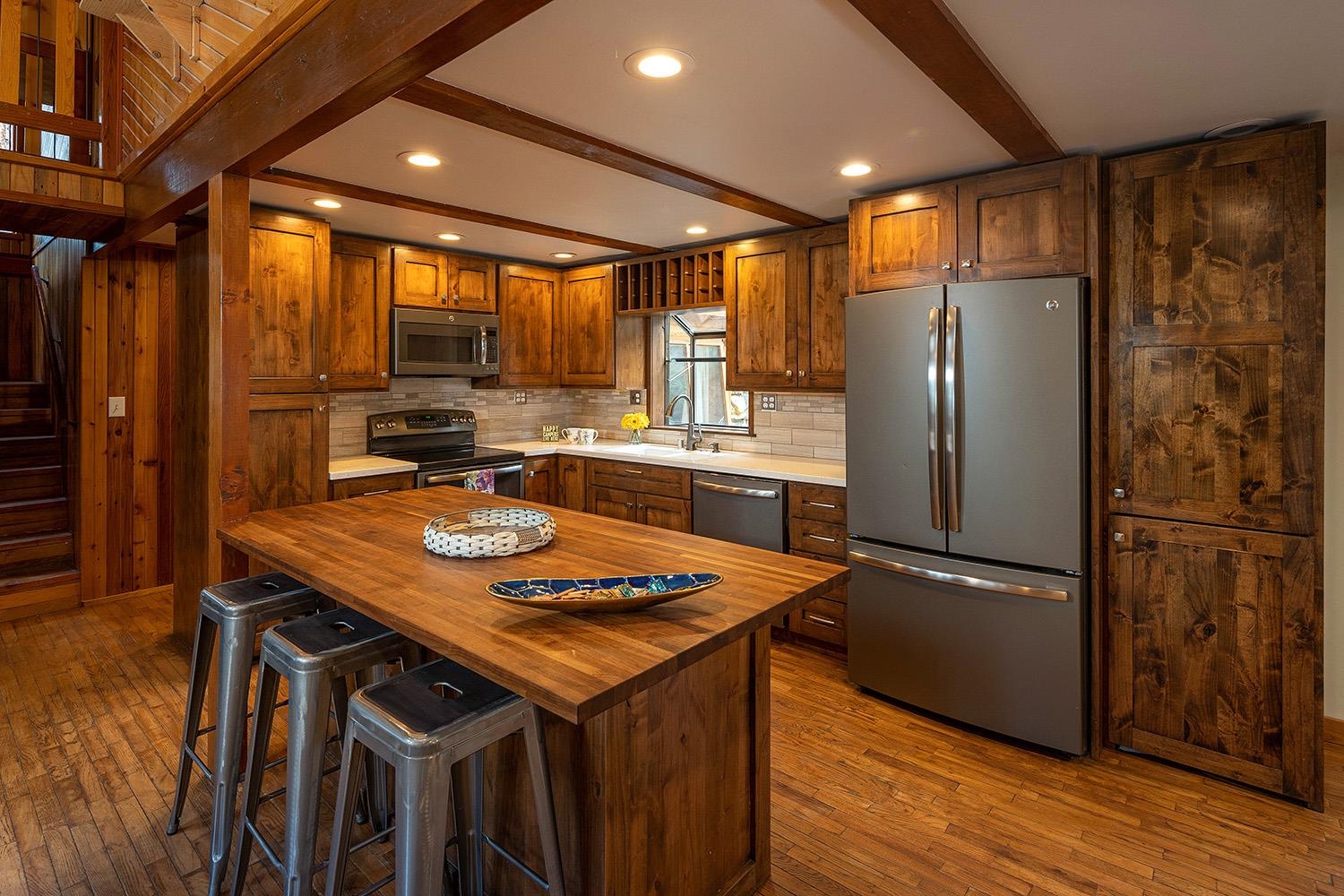 626 Bear Valley Road Loyalton, CA 96118 - Photo 7 of 39 a kitchen with stainless steel appliances granite countertop a refrigerator a sink dishwasher and a stove with wooden floor