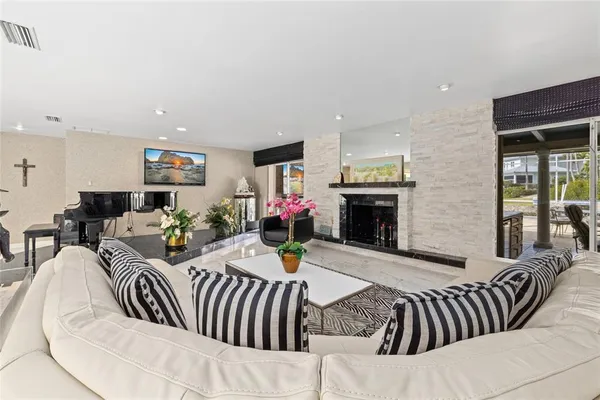 a view of a livingroom with furniture oven kitchen view and a window