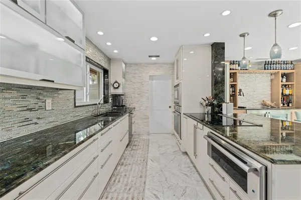 a large kitchen with stainless steel appliances and a counter space