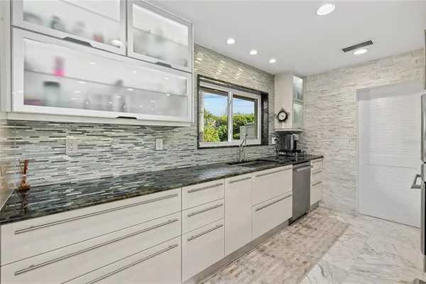 a bathroom with a sink and a large mirror