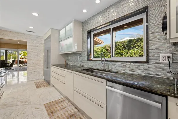 a kitchen with a sink and a large window