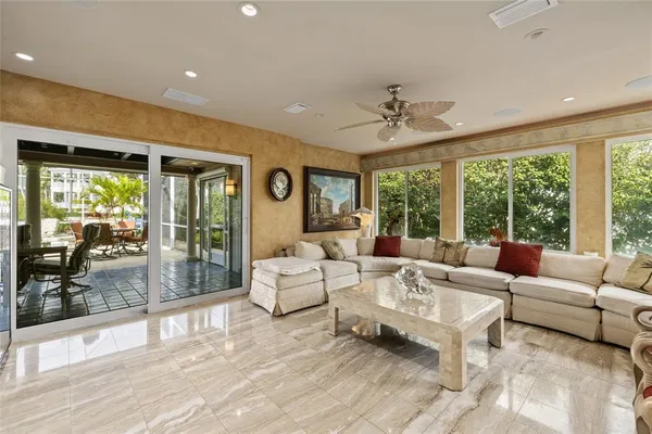 a living room with furniture and large windows
