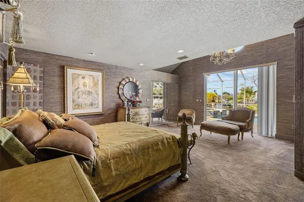 a bedroom with a bed and large windows