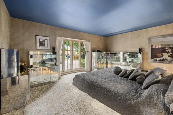 a large bedroom with a large bed and a large window