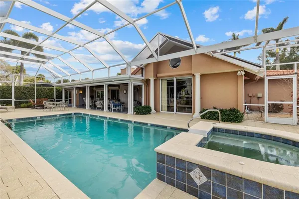 a dining room with furniture and a floor to ceiling window