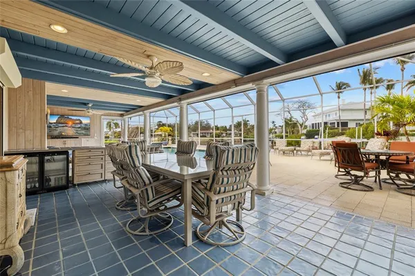 a outdoor space with lots of tables a garden and a couch