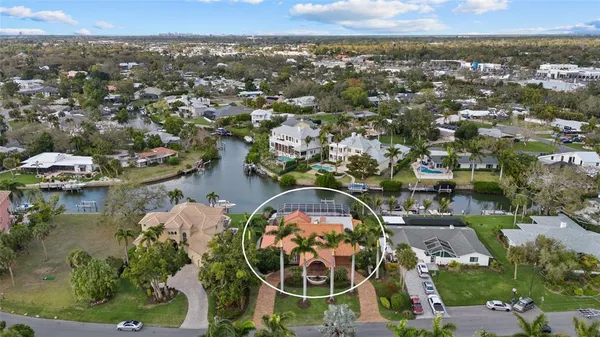 an aerial view of a house with a garden and lake view
