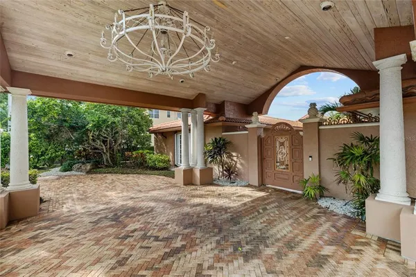 a view of a porch with furniture and garden