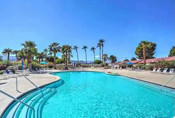 a view of a swimming pool and lounge chair