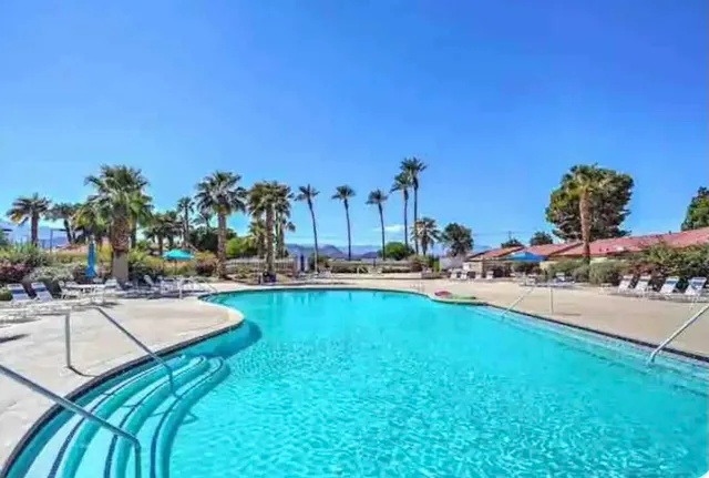 a view of a swimming pool and lounge chair