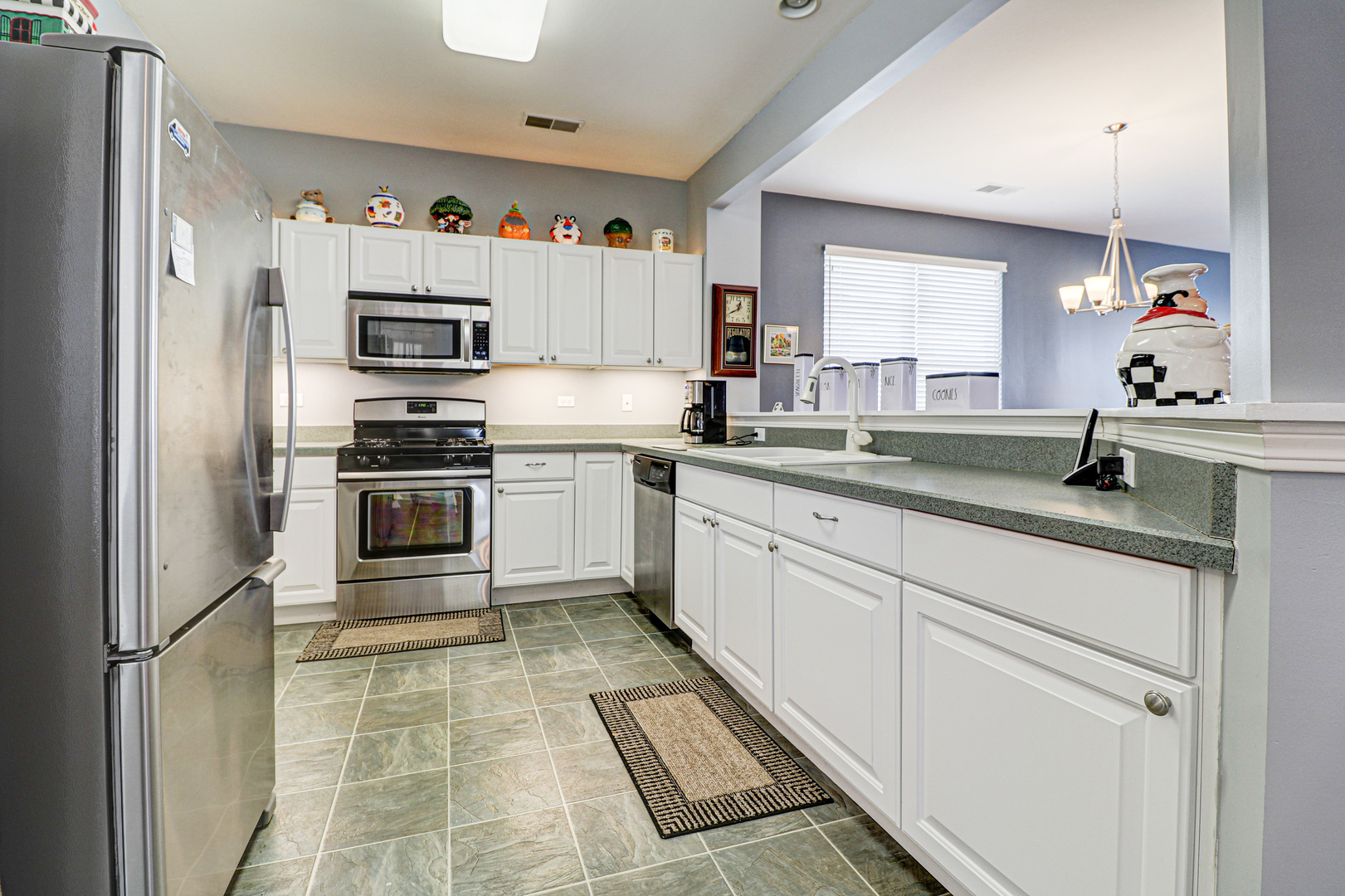 13616 Fallow Drive Huntley, IL 60142 - Photo 6 of 21 a kitchen with stainless steel appliances a sink stove refrigerator and cabinets