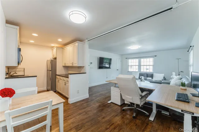 a kitchen with stainless steel appliances granite countertop a kitchen island hardwood floor sink and stove