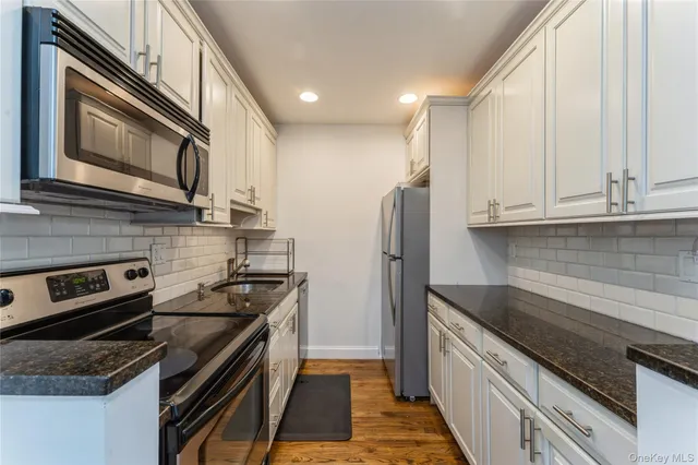 a kitchen with a stove and a microwave