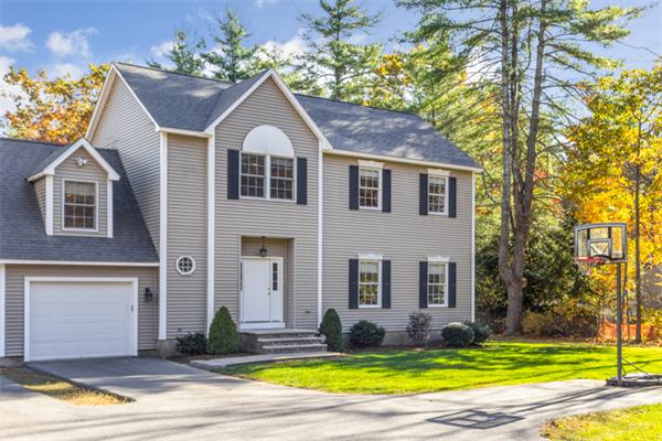 27 A Lawton Road, Unit A Shirley, MA 01464 - Photo 1 of 30 a front view of a house with a yard and garage