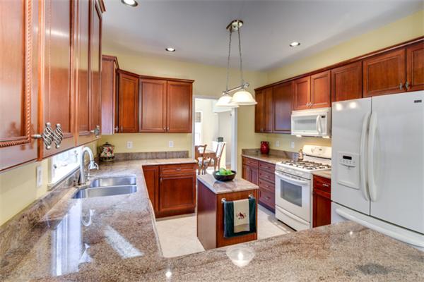27 A Lawton Road, Unit A Shirley, MA 01464 - Photo 12 of 30 a large kitchen with stainless steel appliances granite countertop a stove a refrigerator a sink and a counter top space