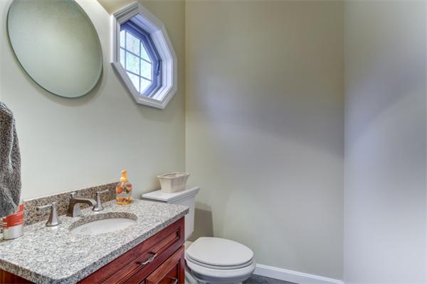 27 A Lawton Road, Unit A Shirley, MA 01464 - Photo 15 of 30 a bathroom with a granite countertop toilet sink mirror and vanity