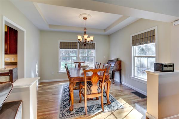 27 A Lawton Road, Unit A Shirley, MA 01464 - Photo 8 of 30 a dining room with furniture a chandelier and wooden floor
