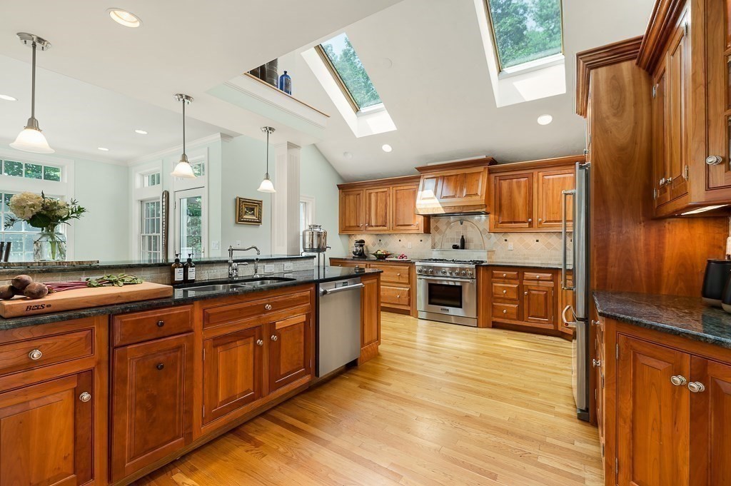 23 Little Pond Road Merrimac, MA 01860 - Photo 8 of 35 a large kitchen with stainless steel appliances wooden floors and wooden cabinets