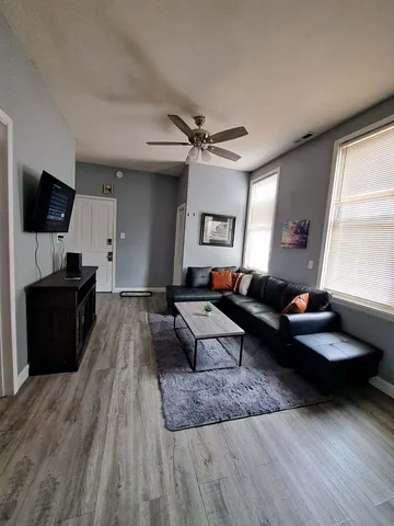 a living room with furniture and a flat screen tv