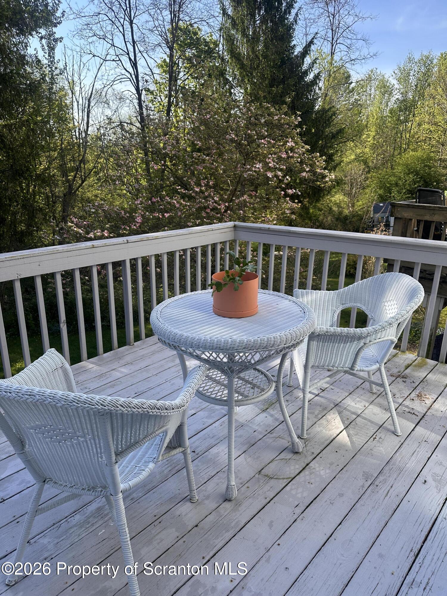 107 Keystone Hls Road, Unit 405 Factoryville, PA 18419 - Photo 3 of 27 a view of a chairs and table on the balcony