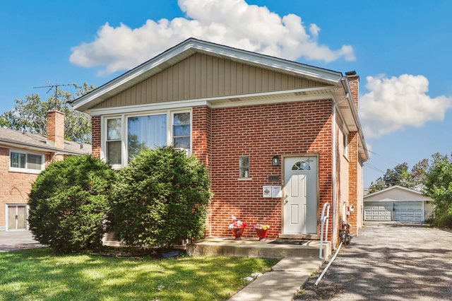 14929 Cleveland Avenue Posen, IL 60469 - Photo 1 of 23 a front view of a house with garden
