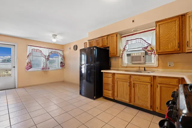 a kitchen with stainless steel appliances granite countertop a refrigerator and a stove top oven