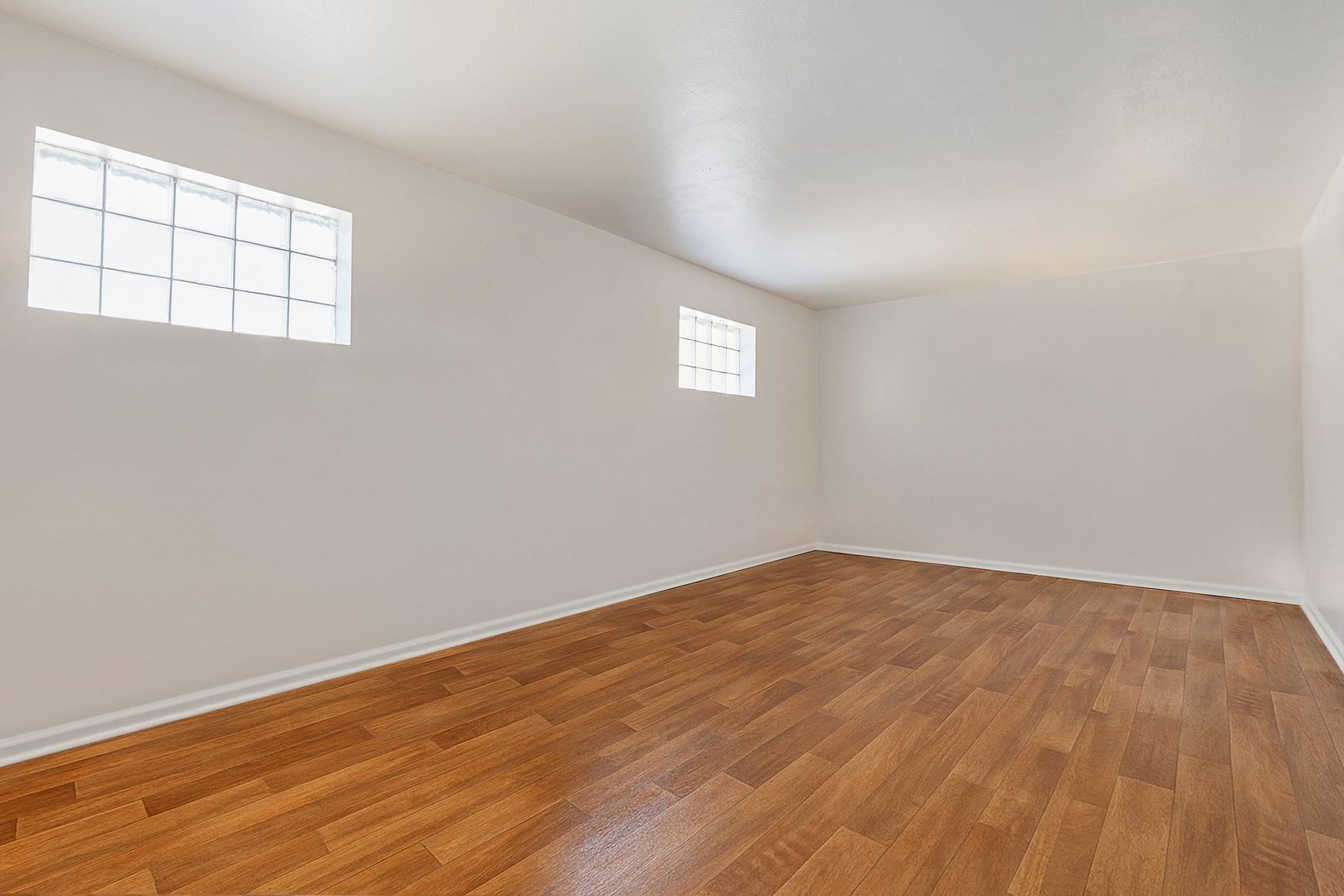 14929 Cleveland Avenue Posen, IL 60469 - Photo 13 of 23 an empty room with wooden floor and windows