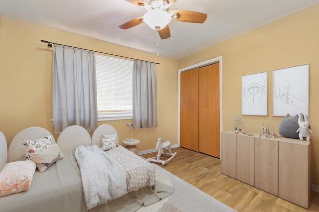 14929 Cleveland Avenue Posen, IL 60469 - Photo 14 of 23 a bedroom with a bed and a chandelier