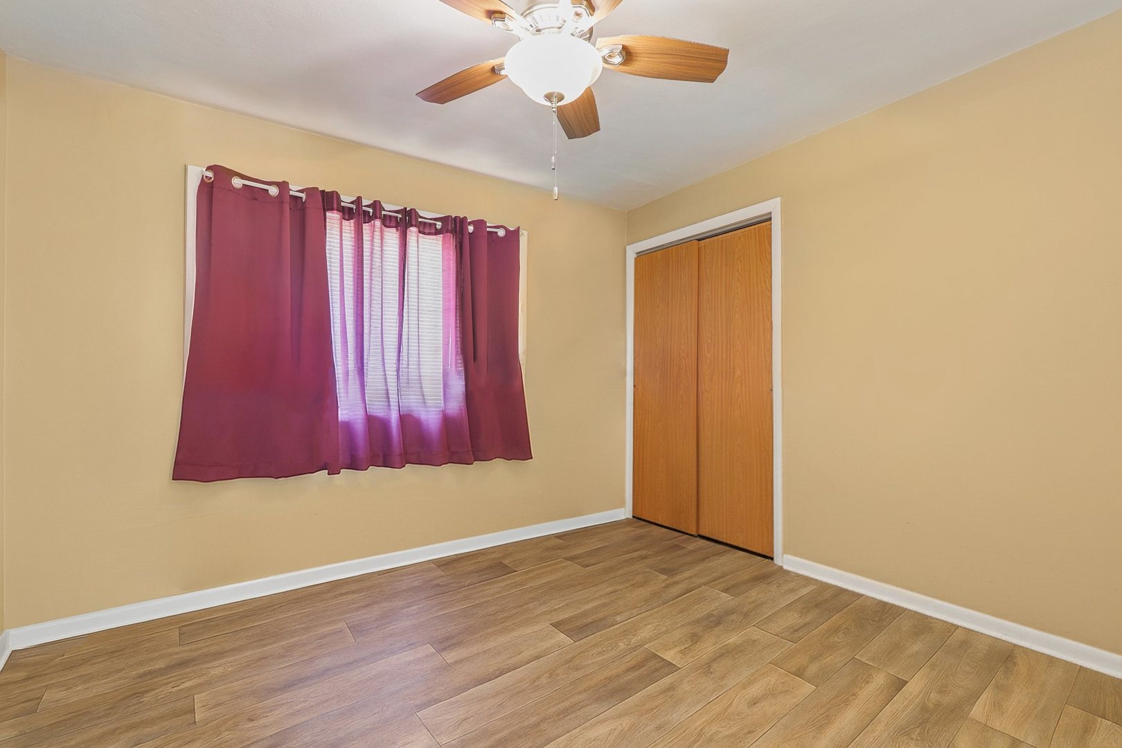 14929 Cleveland Avenue Posen, IL 60469 - Photo 15 of 23 an empty room with wooden floor and windows