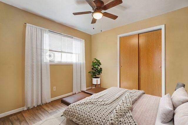 14929 Cleveland Avenue Posen, IL 60469 - Photo 16 of 23 a bedroom with a bed and a chandelier