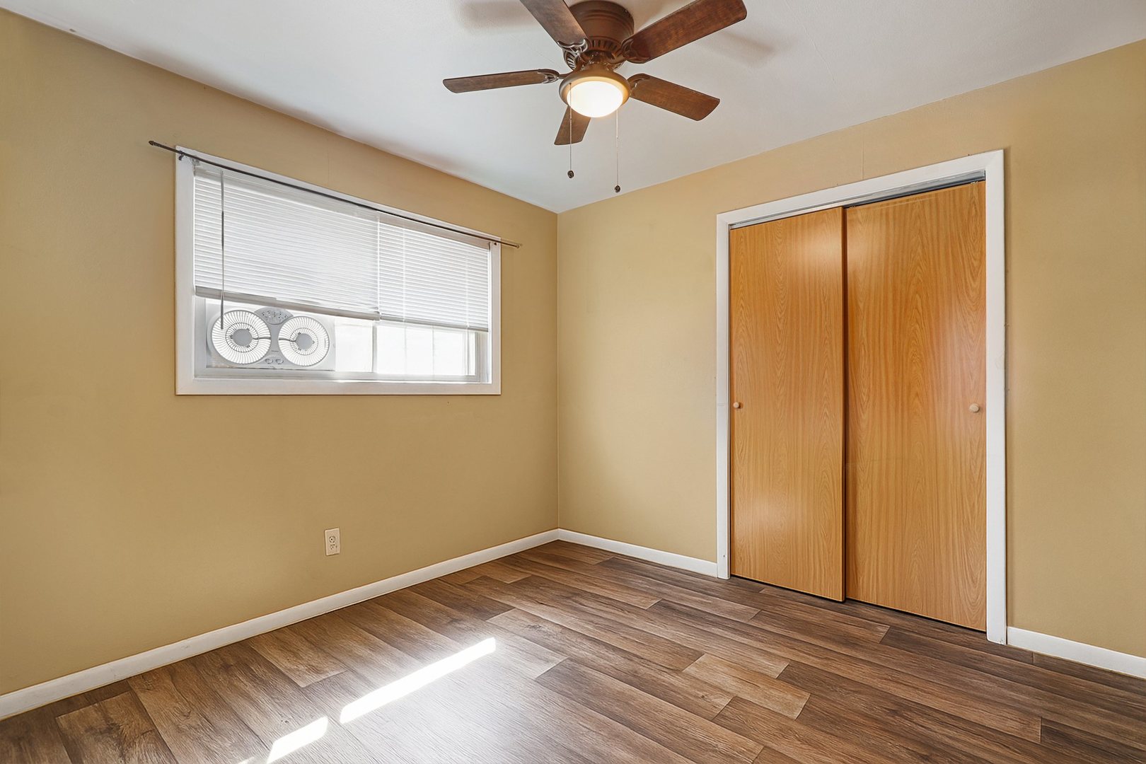 14929 Cleveland Avenue Posen, IL 60469 - Photo 17 of 23 a view of an empty room with wooden floor and a window