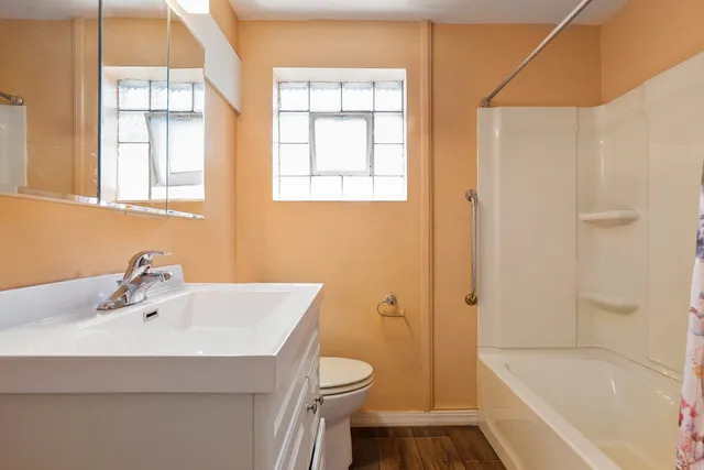 a bathroom with a sink toilet and shower