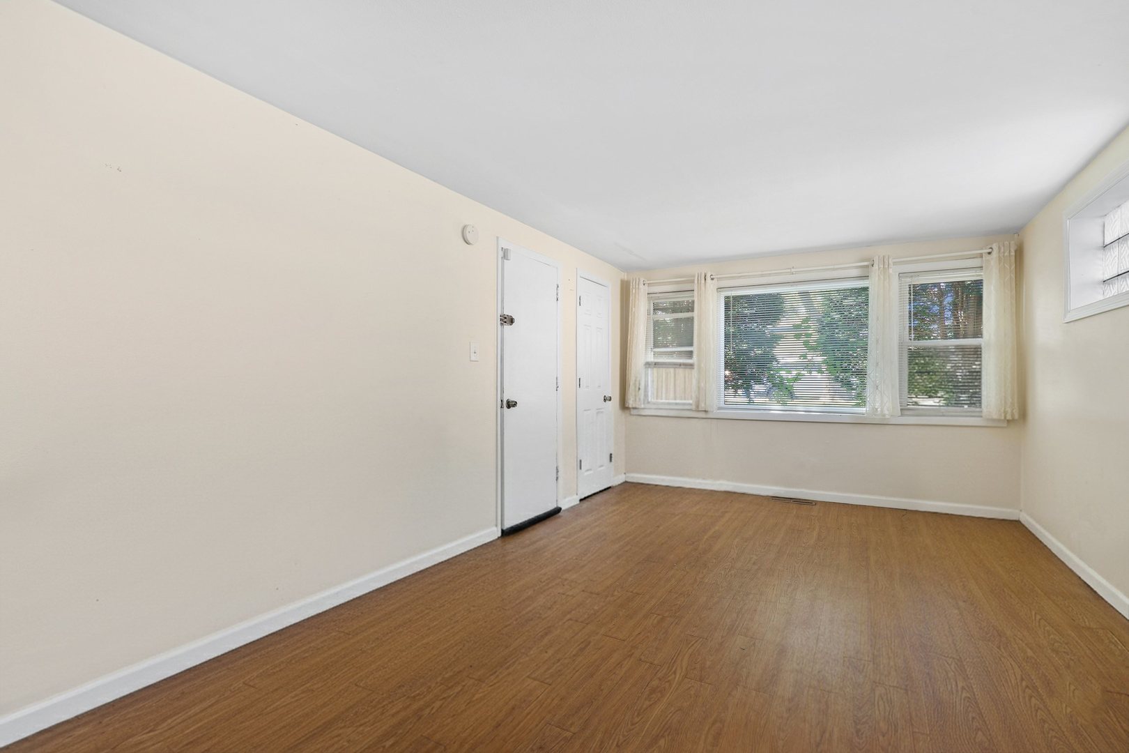 14929 Cleveland Avenue Posen, IL 60469 - Photo 5 of 23 an empty room with wooden floor and windows
