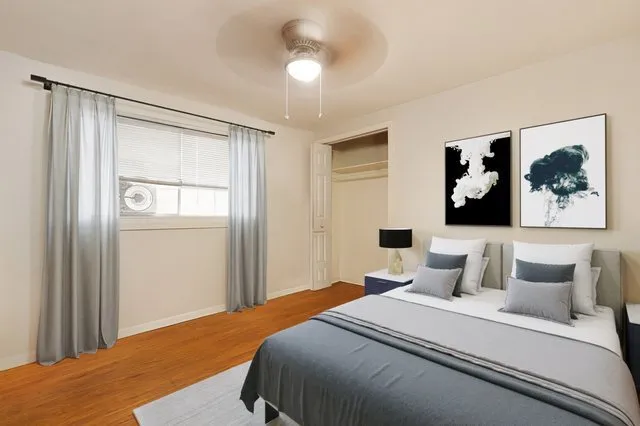 a bedroom with a large bed and a chandelier