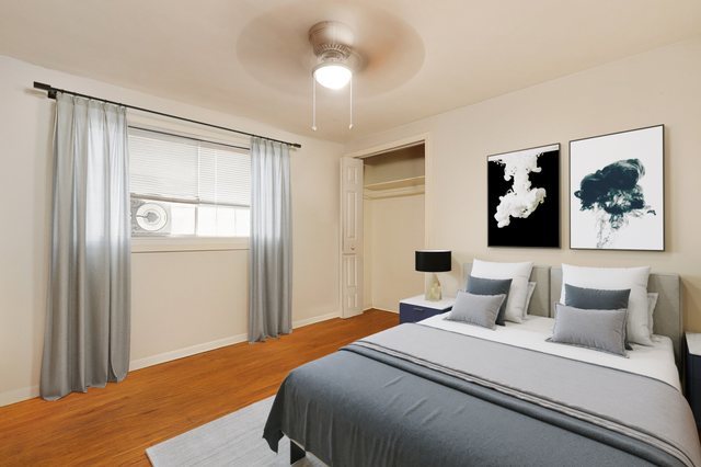 14929 Cleveland Avenue Posen, IL 60469 - Photo 6 of 23 a bedroom with a large bed and a chandelier