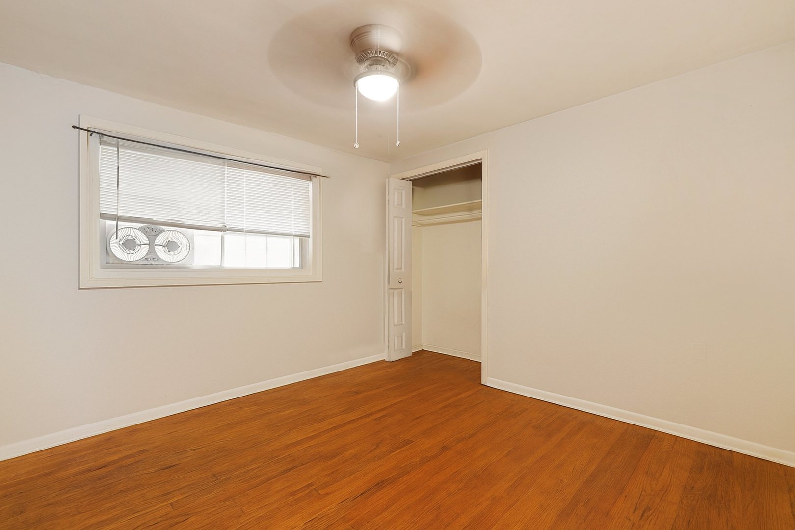 14929 Cleveland Avenue Posen, IL 60469 - Photo 7 of 23 a view of empty room with wooden floor and fan