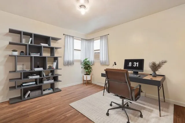 a workspace with furniture window and wooden floor
