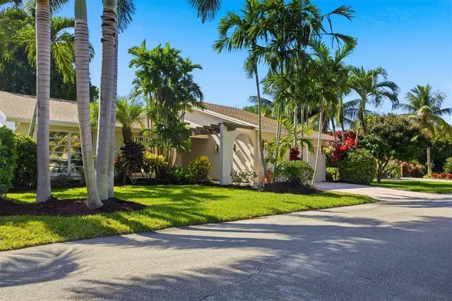 a front view of a house with a yard and a garage