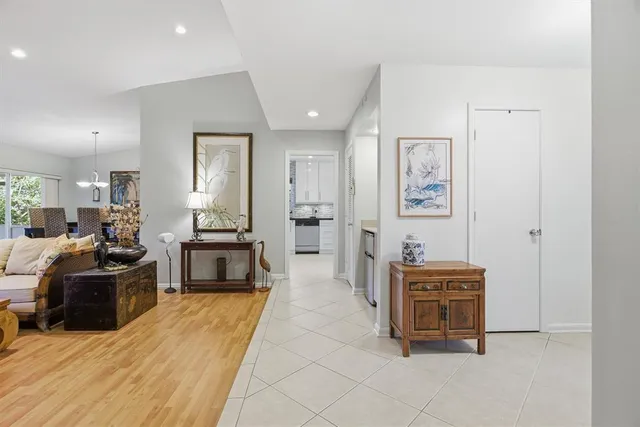 a dining room with furniture a chandelier and wooden floor