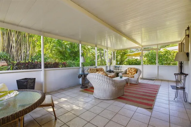 an aerial view of residential houses with outdoor space and trees