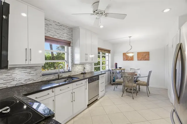 a kitchen with stainless steel appliances kitchen island granite countertop a sink and cabinets