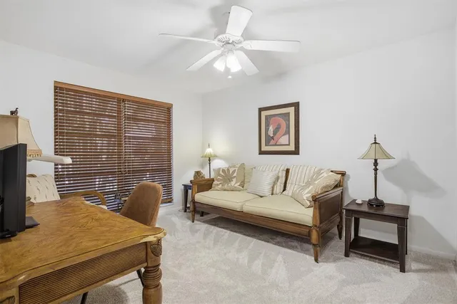 a living room with furniture and a floor to ceiling window