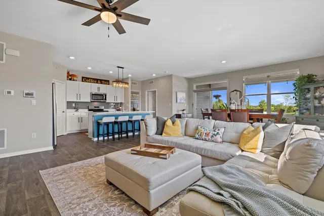 a living room with furniture and kitchen view